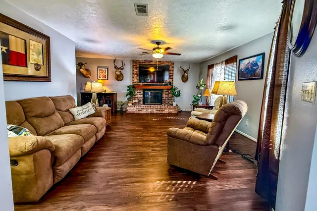 a kitchen with stainless steel appliances granite countertop a stove top oven a sink a dining table and chairs