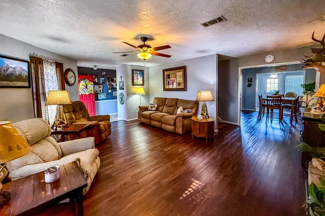 a kitchen with granite countertop cabinets a sink a window and stainless steel appliances