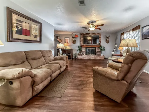 a living room with furniture and wooden floor