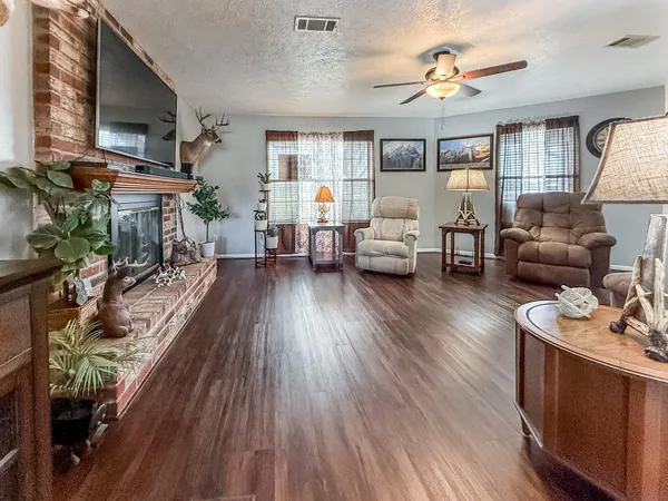 a living room with furniture and a wooden floor