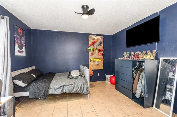 a bedroom with furniture and a flat screen tv
