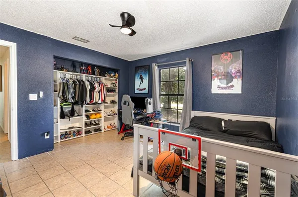 a bedroom that has a bed and a view of kitchen