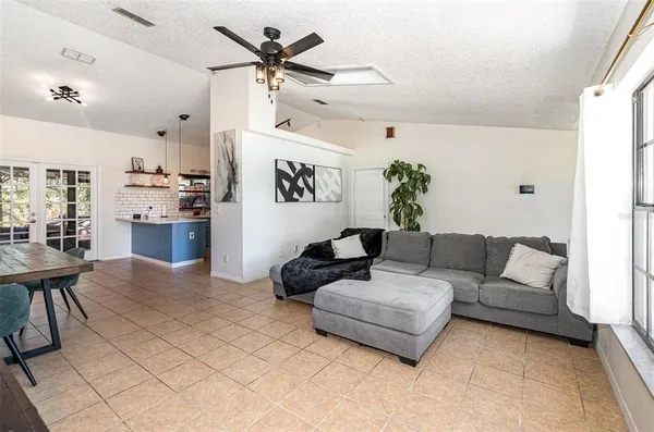 a living room with furniture and kitchen view