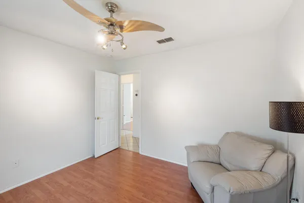 an empty room with a window and a ceiling fan