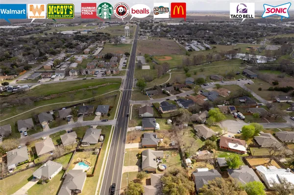 an aerial view of houses with yard