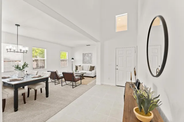 a living room with furniture a table and chairs