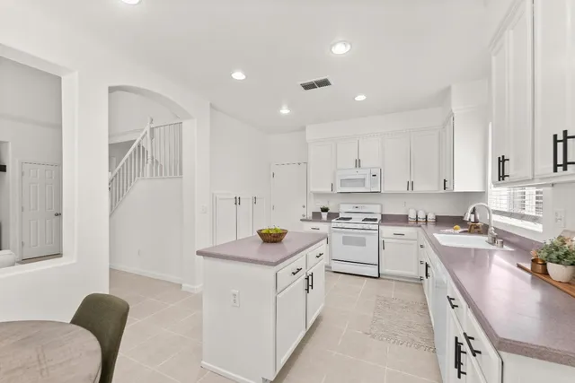 a kitchen with a table and chairs in it