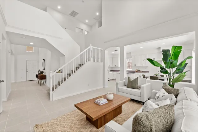 a living room with furniture rug and a table