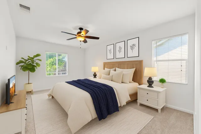 a spacious bathroom with a double vanity sink and a mirror