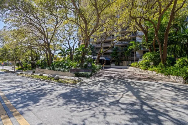 a view of backyard of a house with outdoor seating