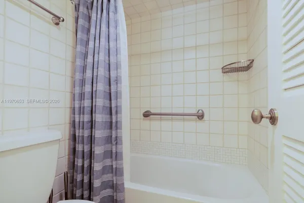 a bathroom with a shower and a bath tub