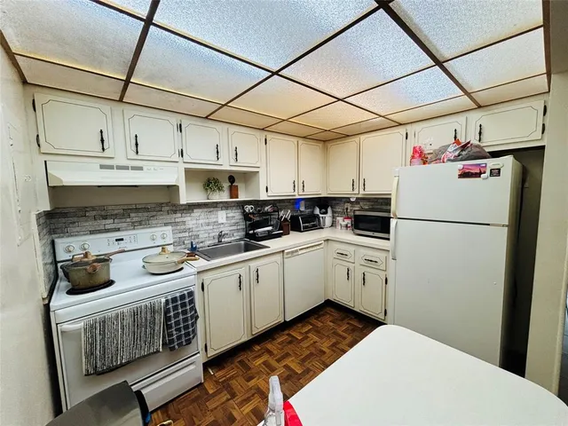 a kitchen with stainless steel appliances granite countertop a refrigerator sink stove and cabinets