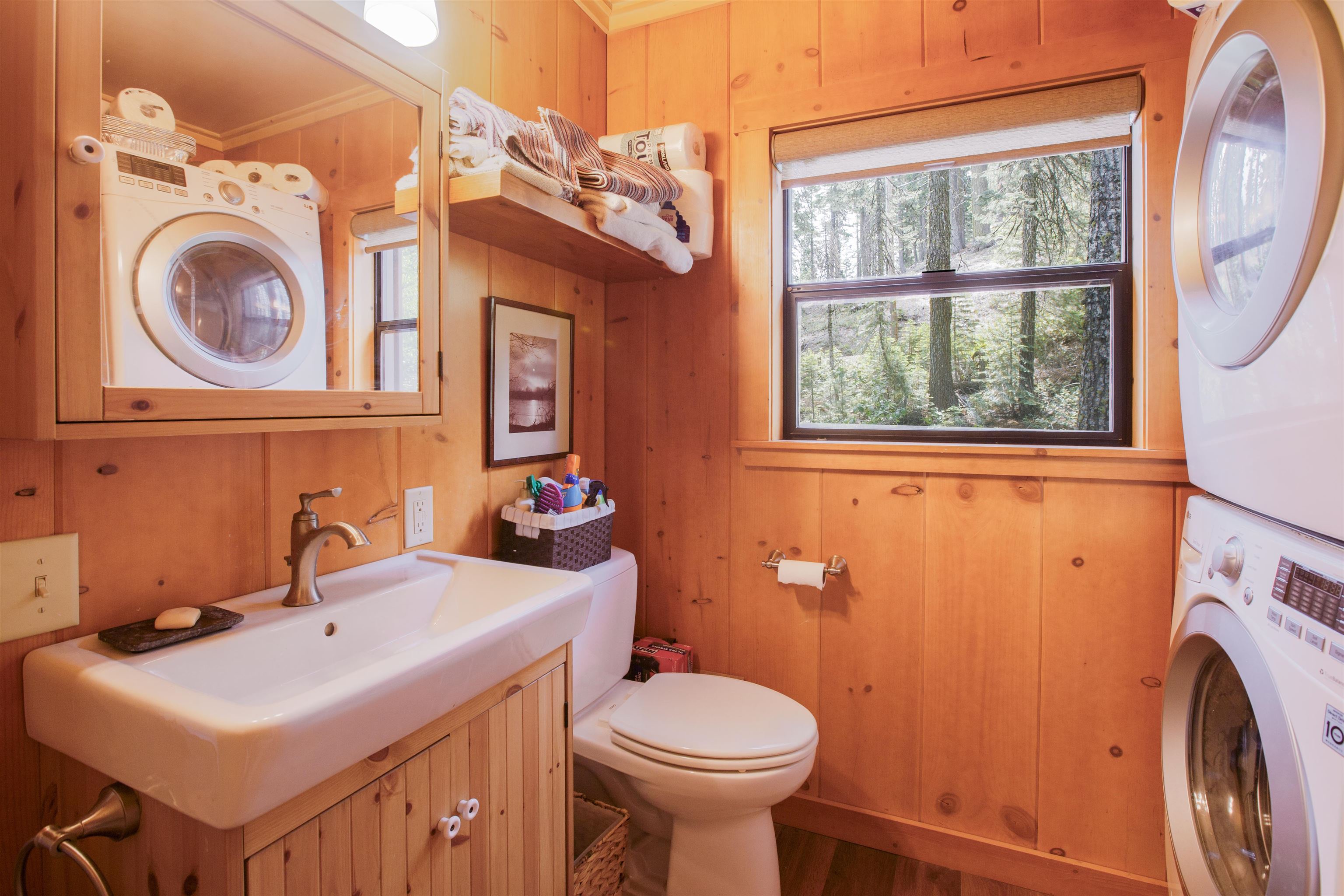 278 Mile High Road Quincy, CA 95971 - Photo 15 of 38 a bathroom with a sink a washer and dryer next to a window