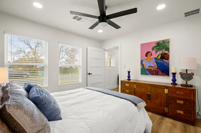 a bedroom with a bed and a painting on the wall