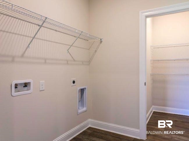 16810 Rocher Court Foley, AL 36535 - Photo 21 of 24 Laundry area with wall-mounted wire shelving, washer/dryer hookups, wood-finish flooring, and a separate closet with additional wire shelving