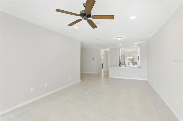 an empty room with a ceiling fan and a window