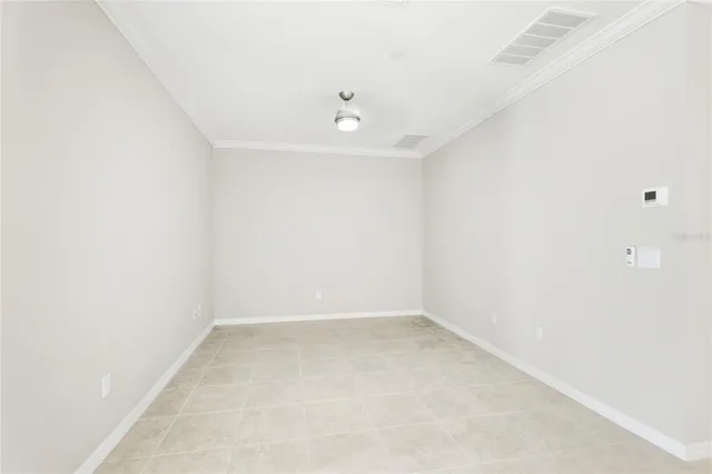 an empty room with a window and ceiling fan