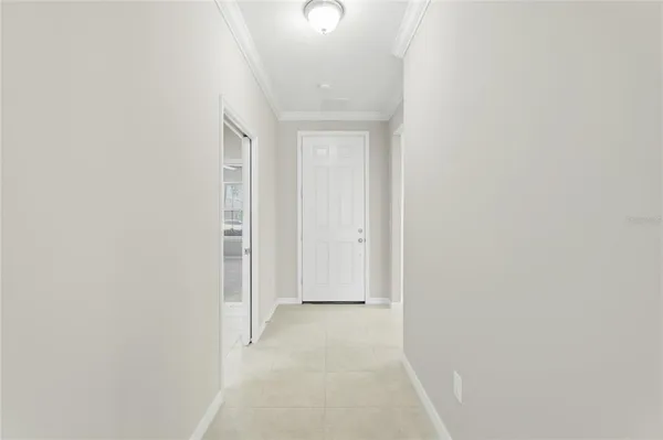 a kitchen with white cabinets and appliances