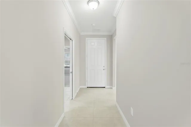 a kitchen with white cabinets and appliances