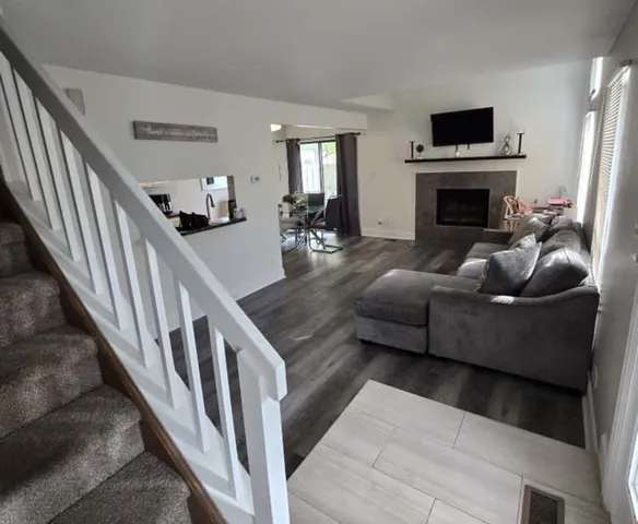 a living room with furniture and a fireplace