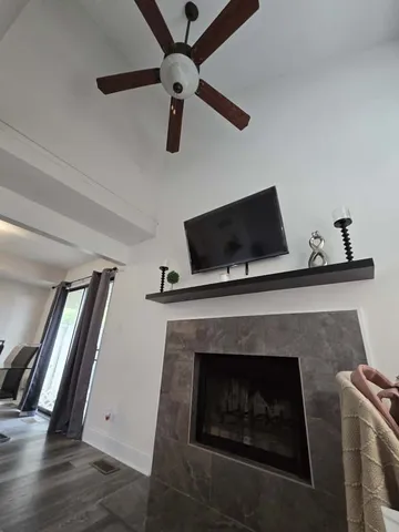 a living room with a fireplace and a flat screen tv