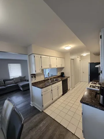 a kitchen with a stove a sink and a refrigerator