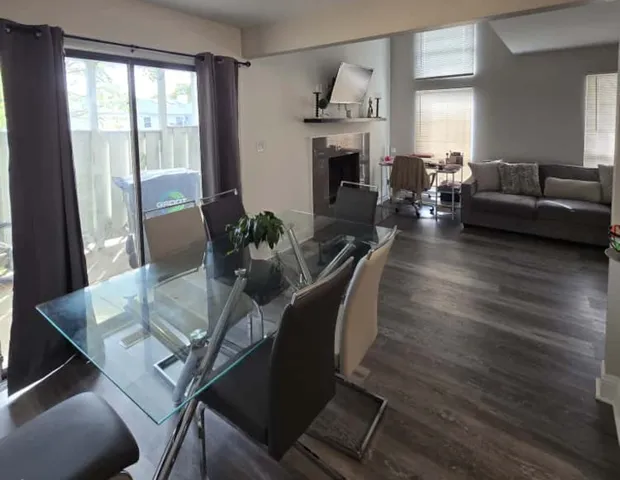 a living room with furniture fireplace and dining table