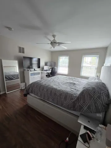 a bedroom with a bed a window and chair