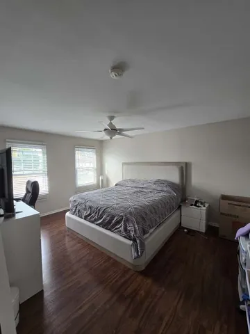 a spacious bedroom with a bed and window