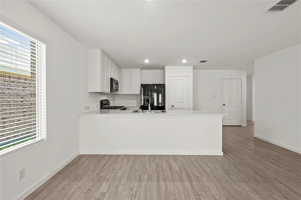 1138 Barbary Flds Street Forney, TX 75126 - Photo 11 of 25 Open-concept living space with wood-finish flooring