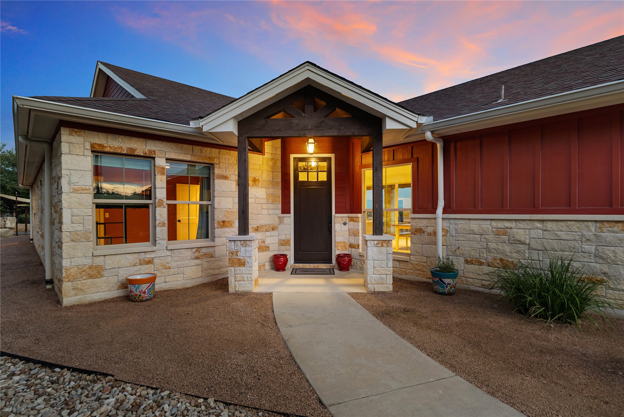 1017 Westland Ridge Road Dripping Springs, TX 78620 - Photo 2 of 40 Natural stone accents and a covered entryway create a welcoming first impression.