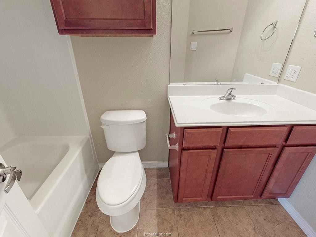 1198 Jones-Butler Road, Unit 2607 College Station, TX 77840 - Photo 14 of 26 a bathroom with a sink a toilet and a mirror