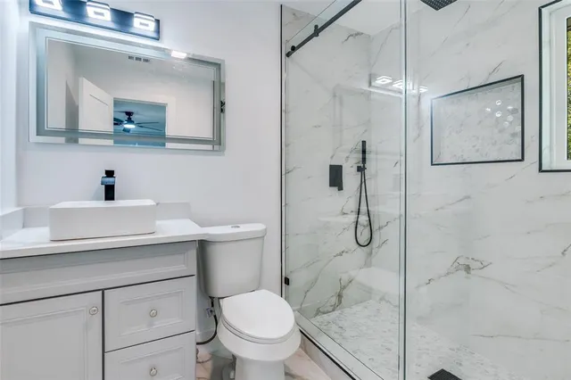 a bathroom with a sink toilet and shower