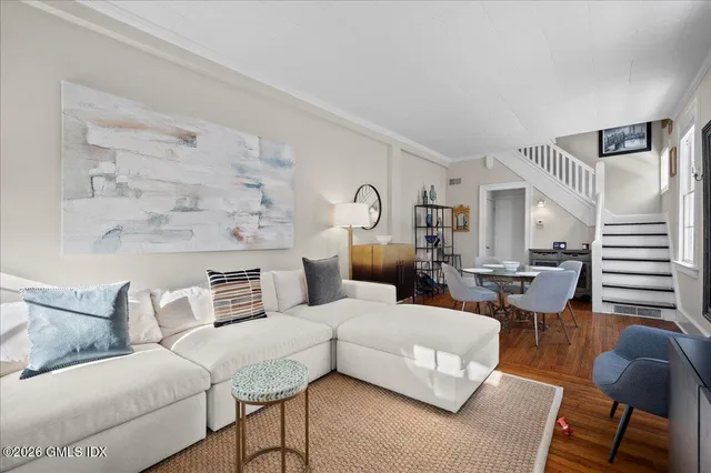 a living room with furniture and wooden floor