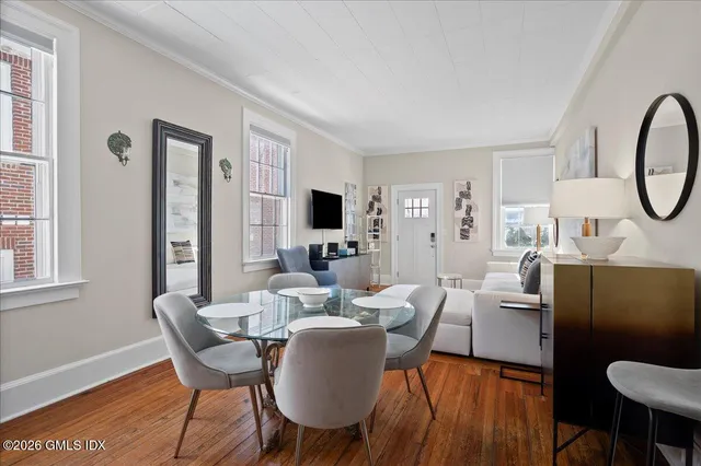 a view of a dining room with furniture window and wooden floor