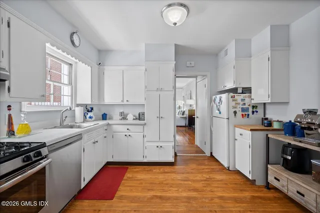 a kitchen with stainless steel appliances a stove refrigerator sink and cabinets