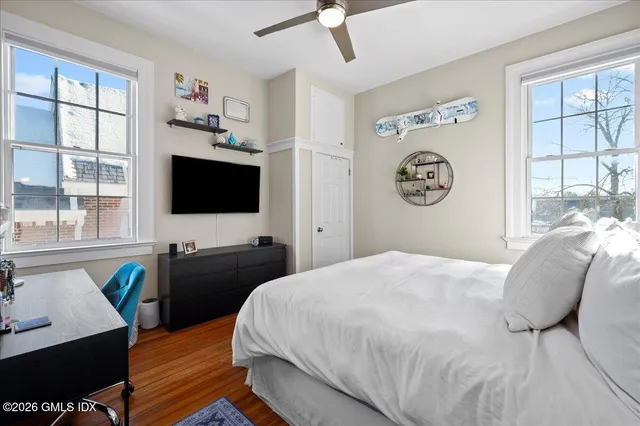 a bedroom with a bed and a flat screen tv