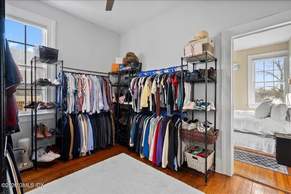 a view of walk in closet with clothes and shoes