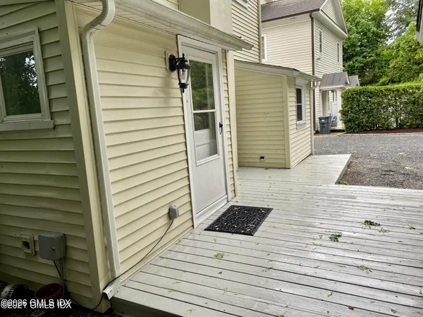 a view of a wooden stairs and two windows