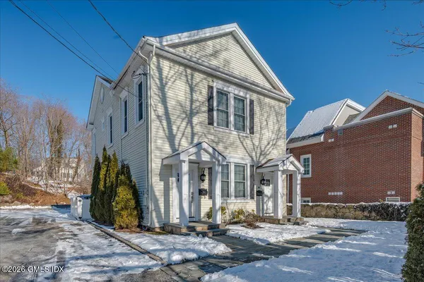 a view of a brick house with many windows