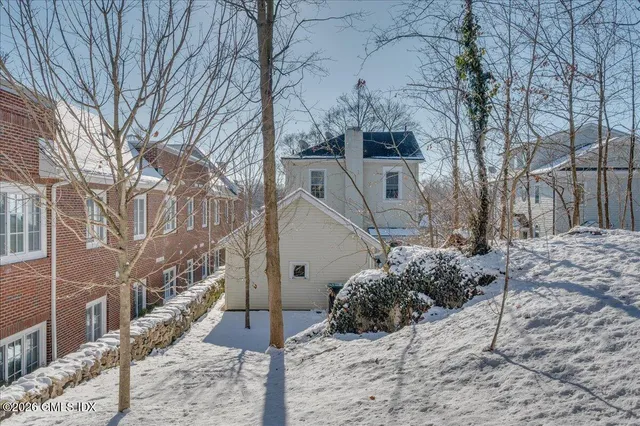 a view of a house with a yard covered in snow