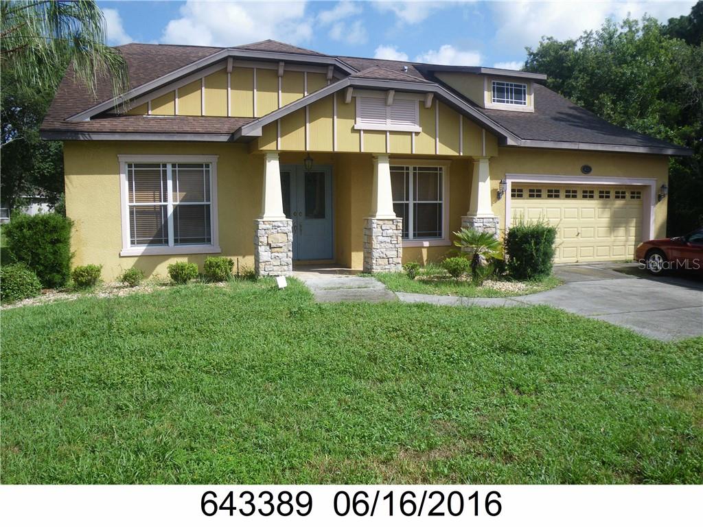 14211 Spring Hill Drive Spring Hill, FL 34609 - Photo 1 of 1 a view of a house with a yard and sitting area