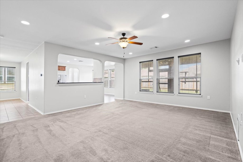 8804 Capitol View Drive Austin, TX 78747 - Photo 8 of 32 an empty room with chandelier fan and windows