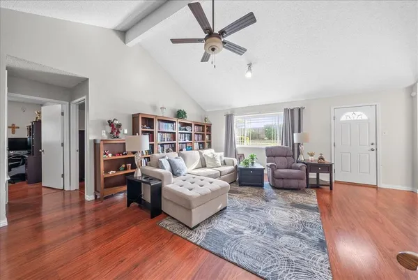 a living room with furniture or couch and a bookshelf