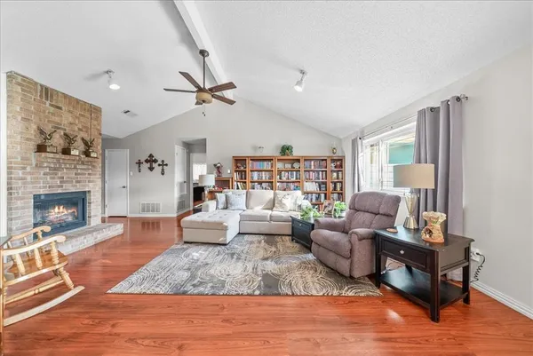 a living room with furniture large window and a fireplace