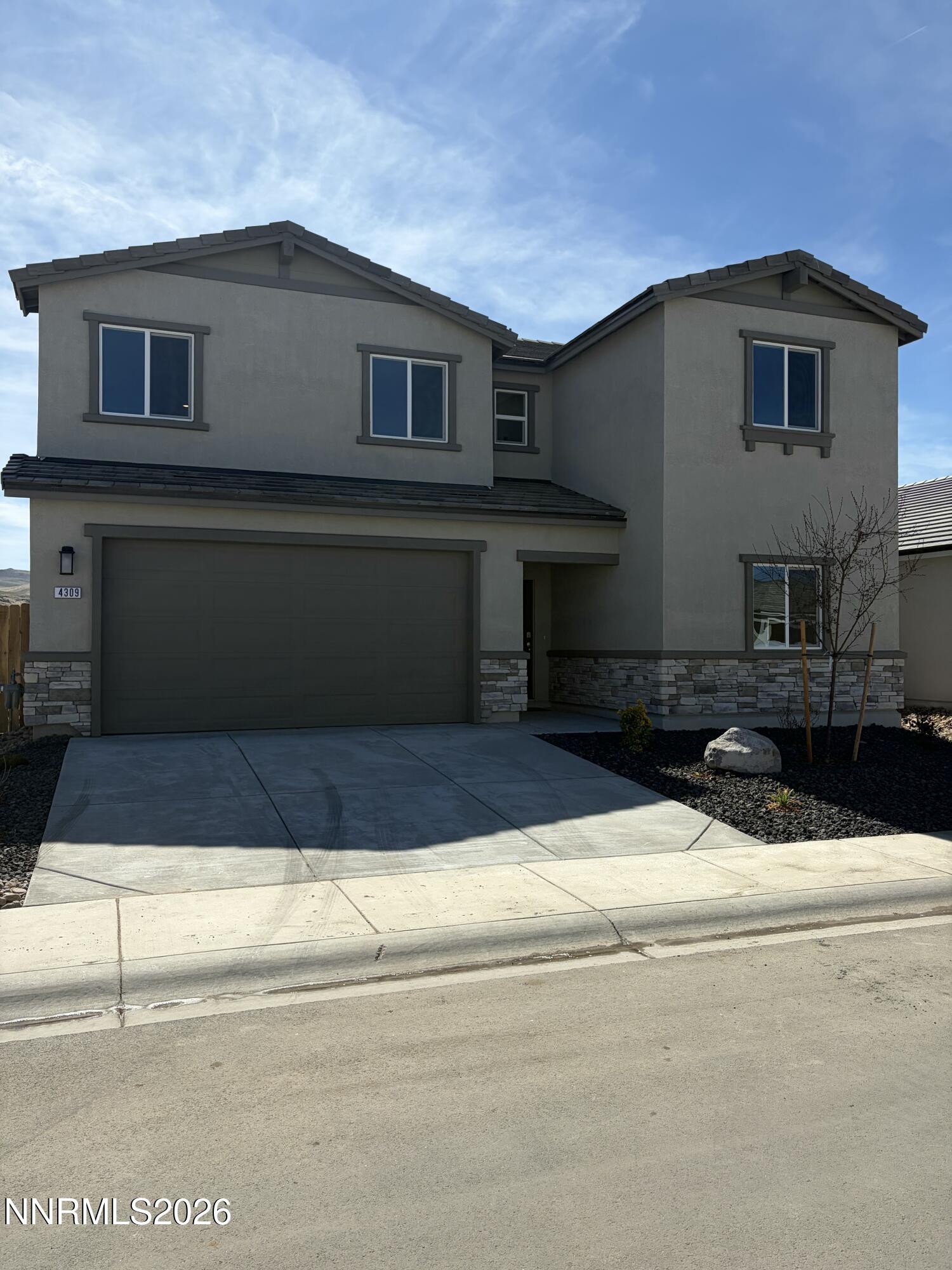 a front view of a house with garage
