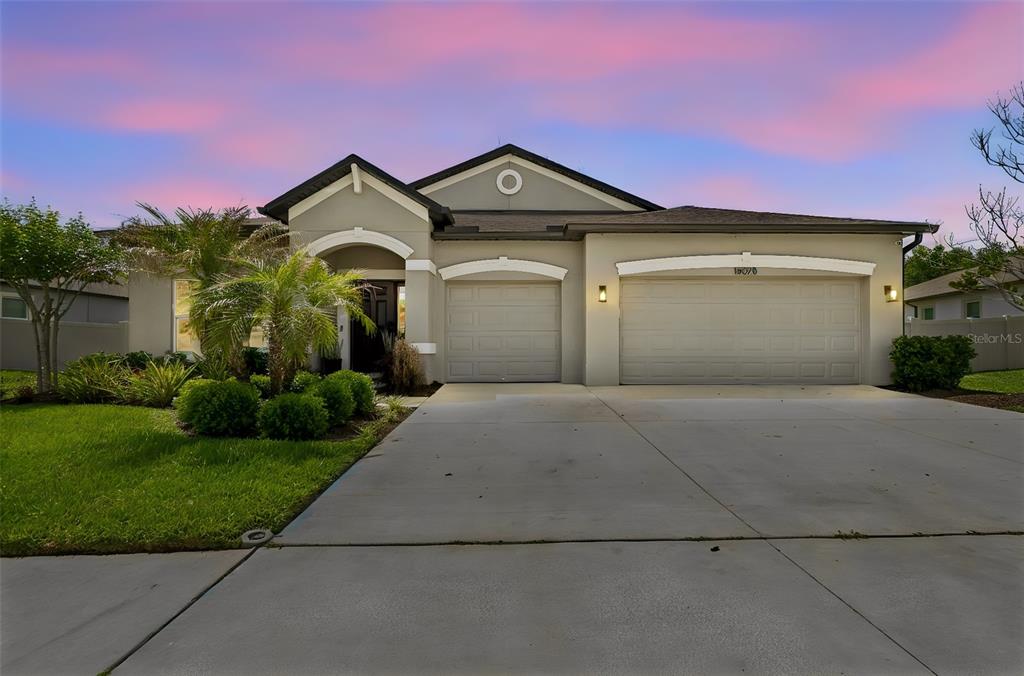 18078 Romanesque Court Spring Hill, FL 34610 - Photo 1 of 81 a front view of a house with a yard and garage
