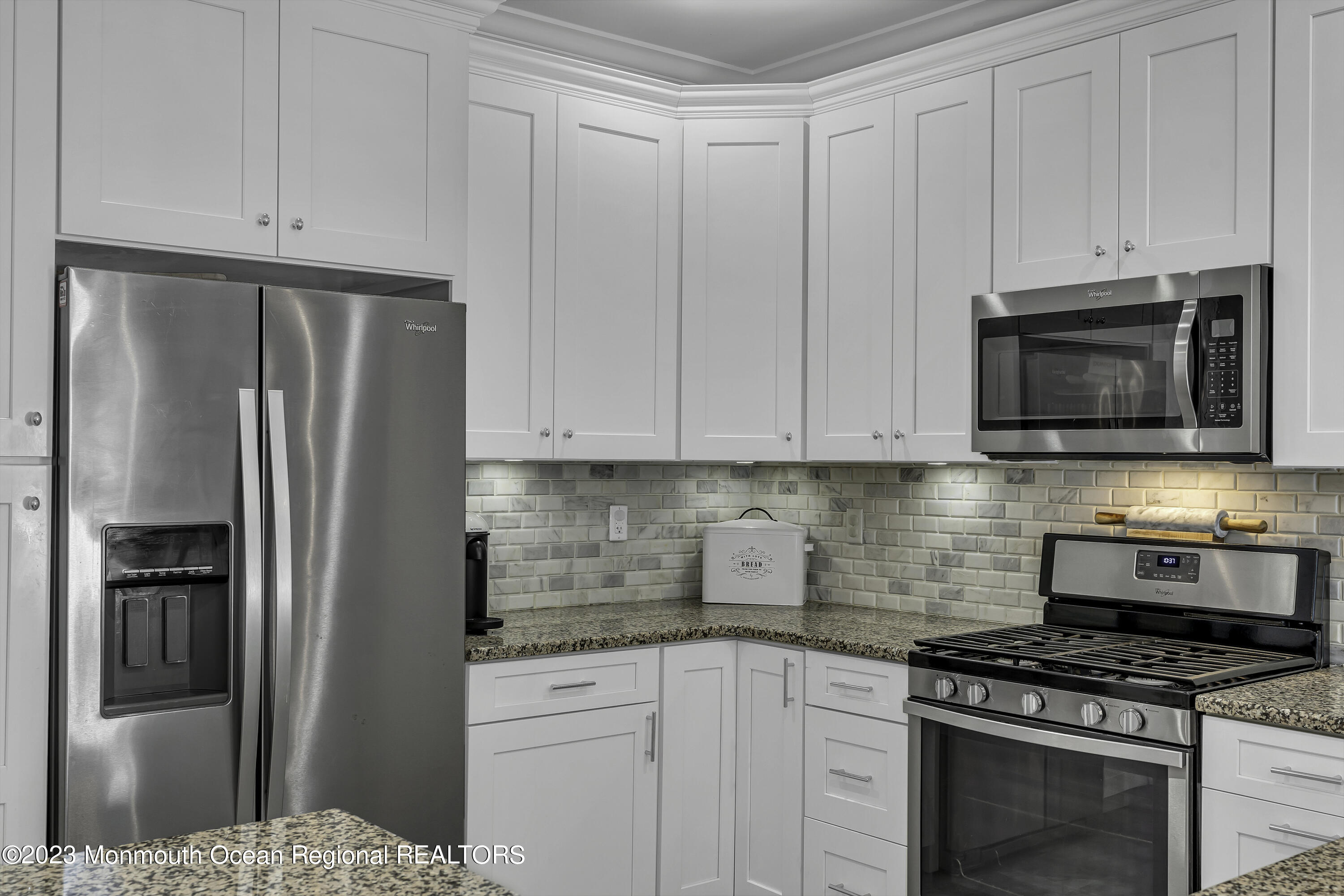 5 Cottrell Court Old Bridge, NJ 08857 - Photo 9 of 49 a kitchen with stainless steel appliances granite countertop a refrigerator stove and white cabinets