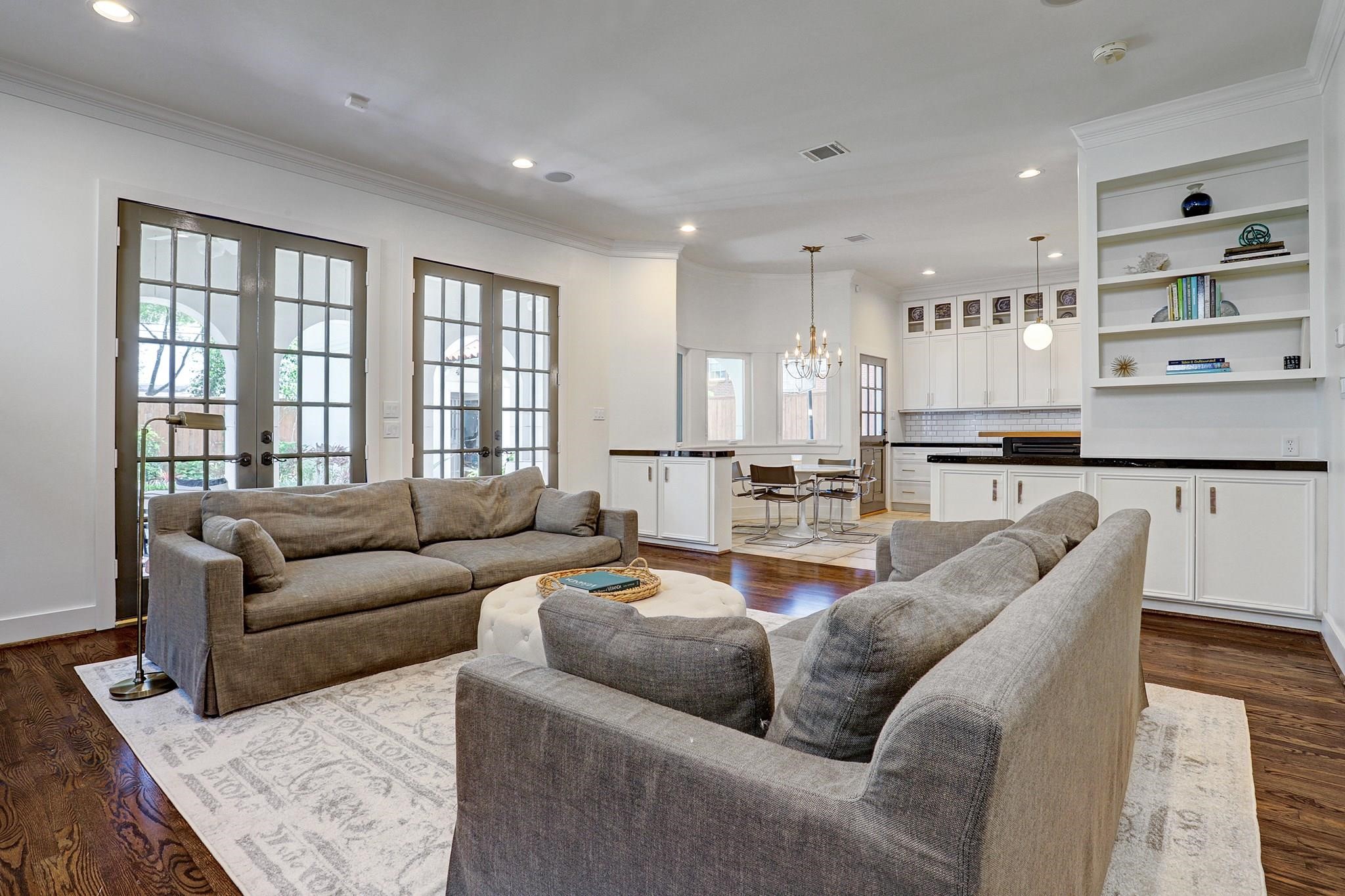 3779 Robinhood Street Houston, TX 77005 - Photo 12 of 17 Family room with fireplace opens to the covered patio and backyard.