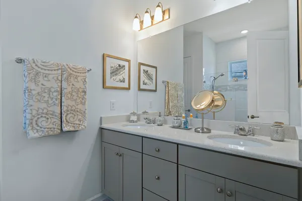 a bathroom with a double vanity sink and a mirror